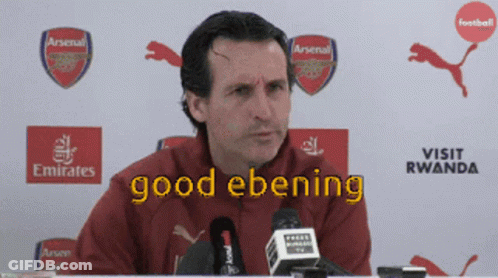 Man At Microphone With Good Ebening On Screen GIF