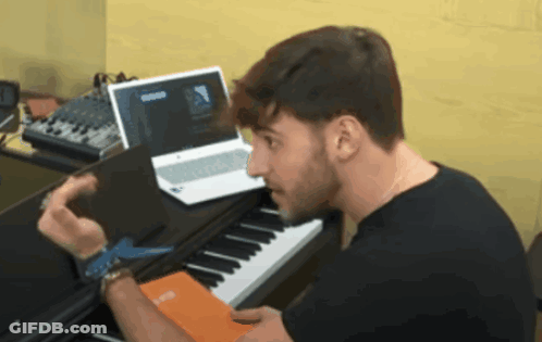 Man At Piano Looking At Laptop Saying Groove GIF