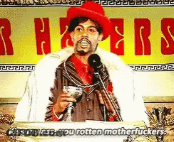 Man At Podium Holding Martini Saying Kiss My Ass You Rotten Motherfucker GIF
