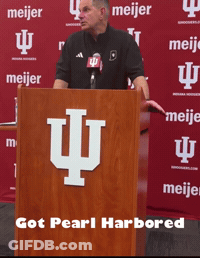 Man At Podium In Front Of Meijer Banner GIF