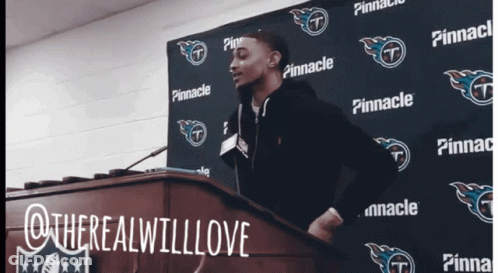 Man At Podium In Front Of Pinnacle Sign GIF