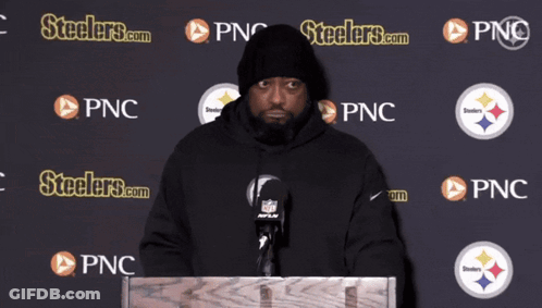Man At Podium In Front Of Wall Saying Steelers.com GIF