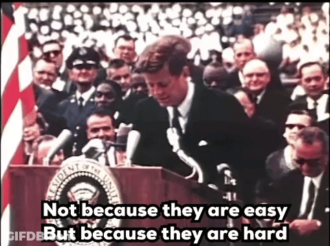 Man At Podium Saying Not Because They Are Easy But Because They Are Hard GIF