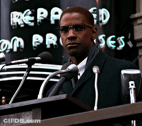 Man At Podium Speaking Into Microphones With Repealed On Process Sign GIF