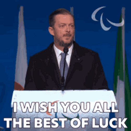 Man At Podium Wishes Best Of Luck GIF