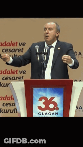 Man At Podium With 36 Sign GIF