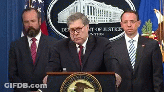 Man At Podium With Department Of Justice Logo GIF