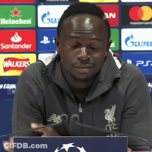 Man At Podium With Heineken Santander Mastercard Logos GIF