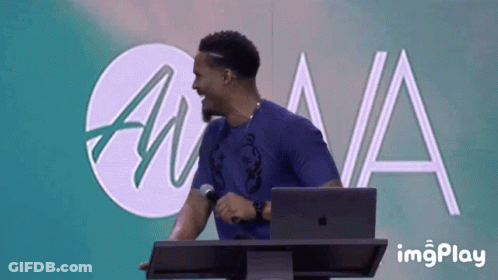 Man At Podium With Microphone And Laptop GIF