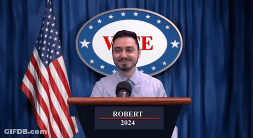 Man At Podium With Robert 2024 GIF
