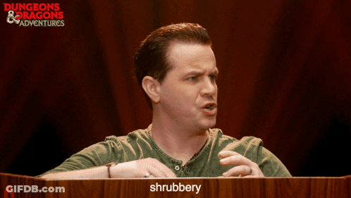 Man At Podium With Shrubbery Sign GIF