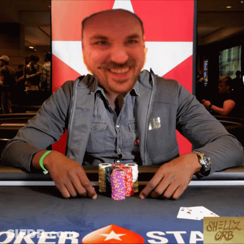 Man At Poker Table With Chips And Shelly Orb Sign GIF