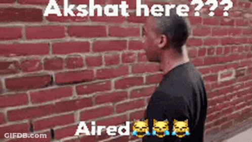Man At Red Brick Wall Says Akshit Here GIF