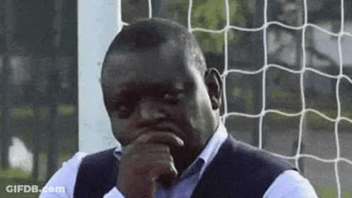 Man At Soccer Net Hand On Chin Looking At Camera GIF