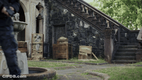 Man At Stone Building With Stairs And Fountain GIF