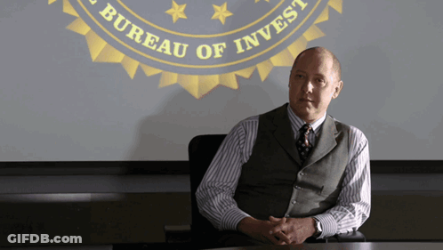 Man At Table In Front Of Bureau Of Invest Screen GIF