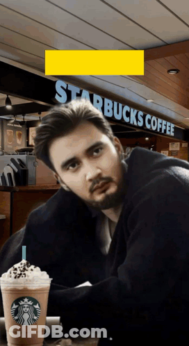Man At Table In Front Of Starbucks GIF