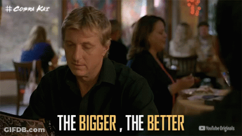 Man At Table Saying The Bigger The Better GIF