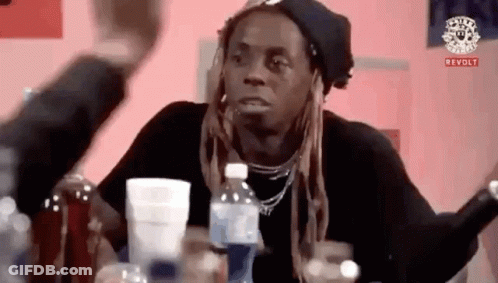 Man At Table With Bottles And Cup GIF
