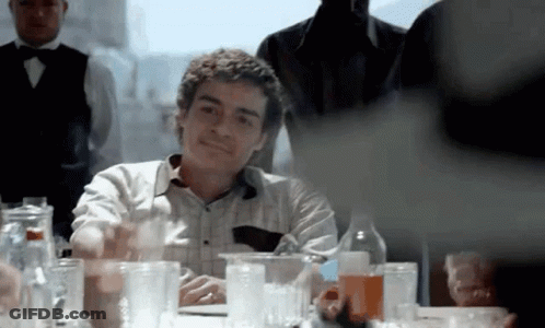 Man At Table With Bunch Of Glasses GIF