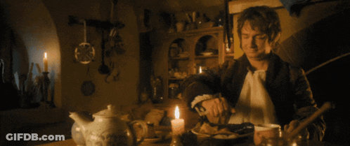 Man At Table With Candle Doorbell Rings GIF