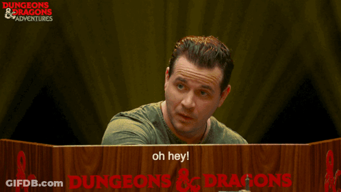Man At Table With Dungeons And Dragons Sign GIF