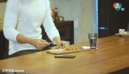 Man At Table With Glass Of Water And Phone GIF