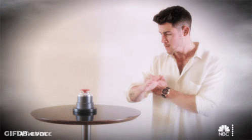 Man At Table With NBC Logo GIF