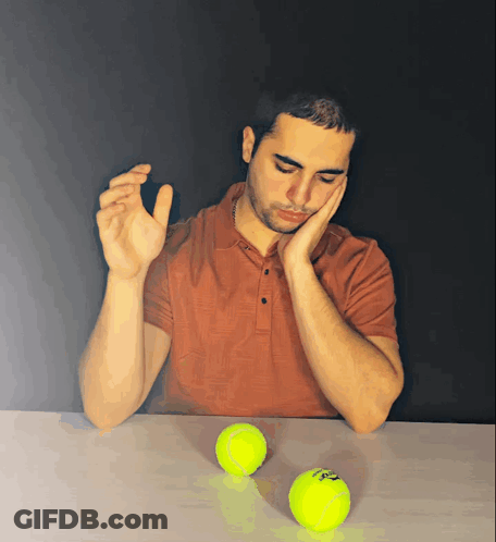 Man At Table With Slazenger Tennis Balls GIF