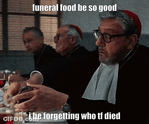 Man At Table With Wine Saying Funeral Food GIF