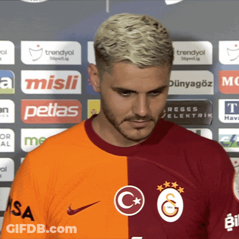 Man At Wall Of Petlas And Misli Ads GIF