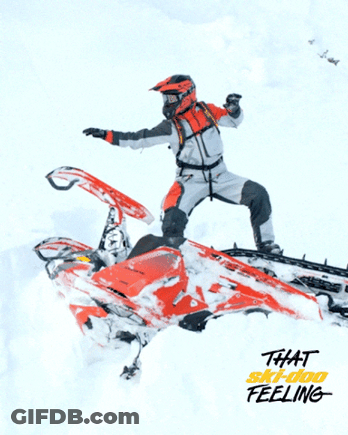 Man Balancing On Top Of His Snowmobile GIF