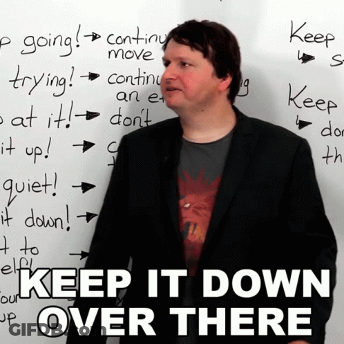 Man Before White Board Saying Keep It Down Over There GIF