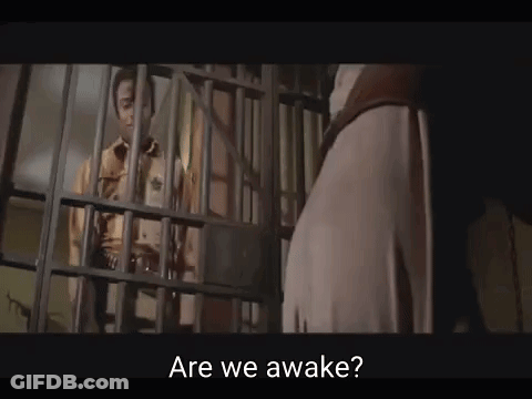 Man Behind Bars Jail Cell Are We Awake GIF