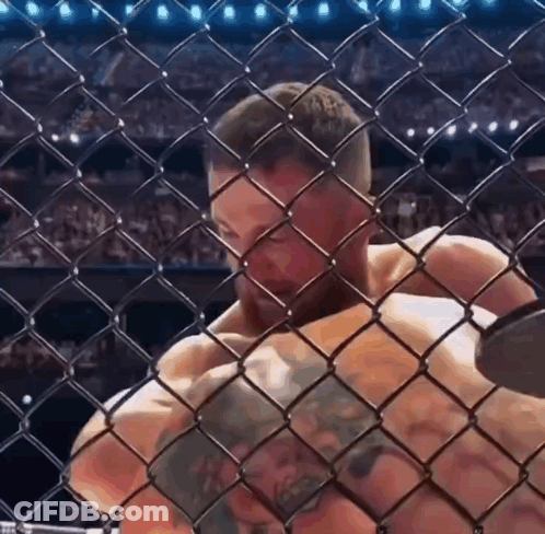 Man Behind Chain Link Fence In Cage GIF