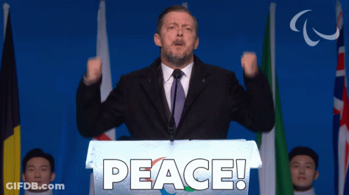 Man Behind Podium Saying Peace GIF