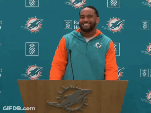 Man Behind Podium With Dolphin Logo GIF