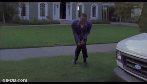 Man Bending Over In Front Of White Ford Truck GIF