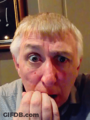 Man Biting Nails In Front Of Clock GIF