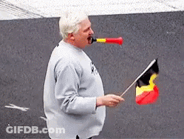 Man Blowing Horn And Holding Flag GIF