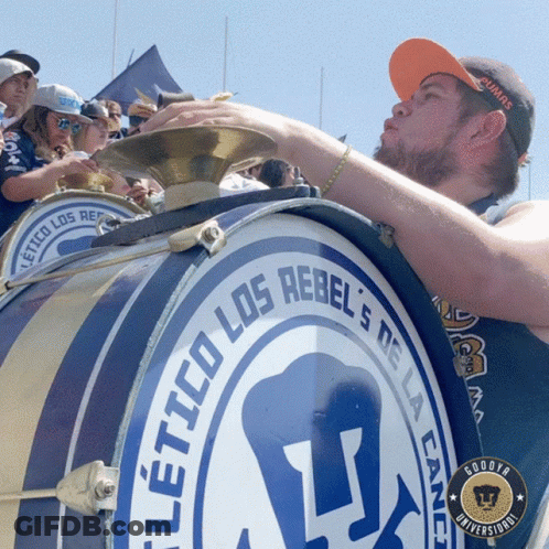 Man Blowing Into Drum Los Rebels GIF