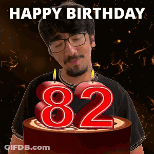 Man Blowing Out Candles On Birthday Cake Saying 82 GIF