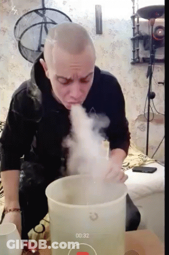Man Blowing Smoke Out Of Bucket 00:32 GIF