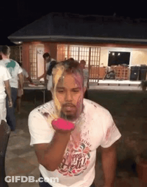 Man Blows Pink Powder GIF