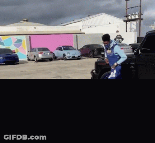 Man Blue Shorts White Socks Approaches Black Car GIF