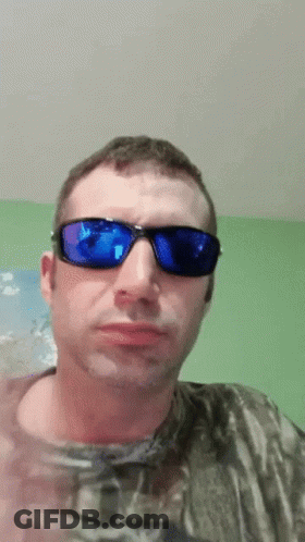 Man Blue Sunglasses Camo Shirt Looking At Camera GIF