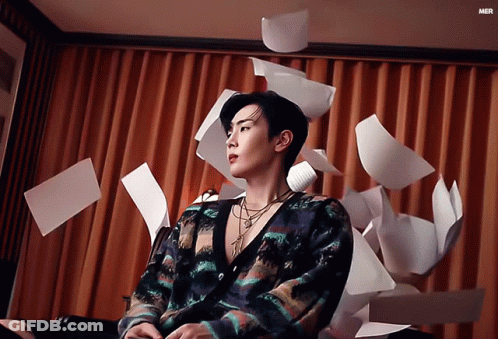 Man By Curtain Papers Falling Mer GIF