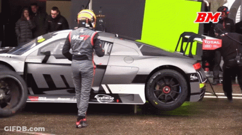 Man By Race Car Saying Total GIF