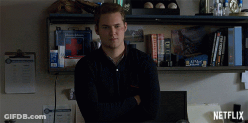 Man By Shelf With First Aid Kit And Netflix Logo GIF