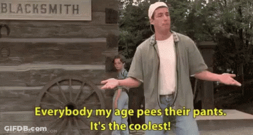 Man By Sign Everybody My Age Pees Their Pants GIF